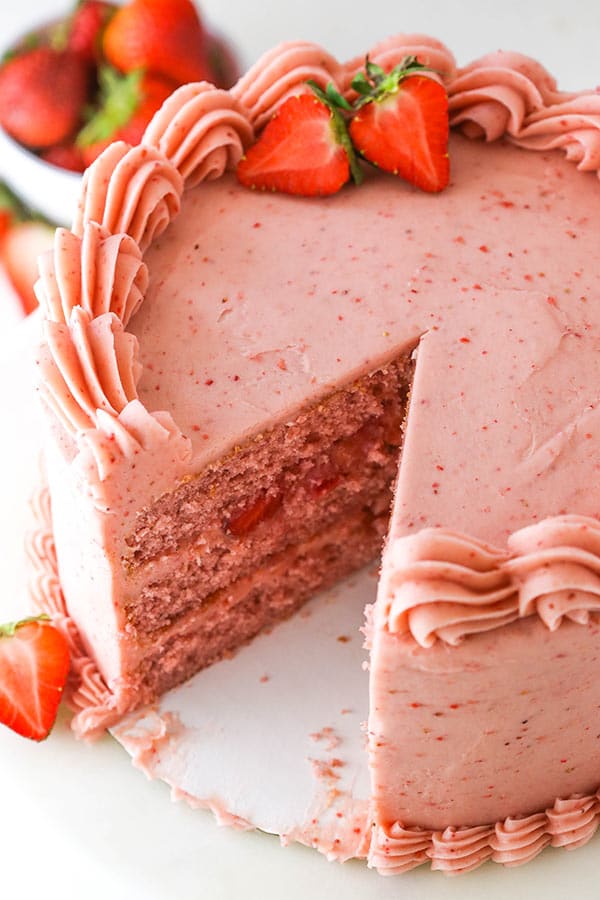 overhead of homemade fresh strawberry cake with a slice cut out