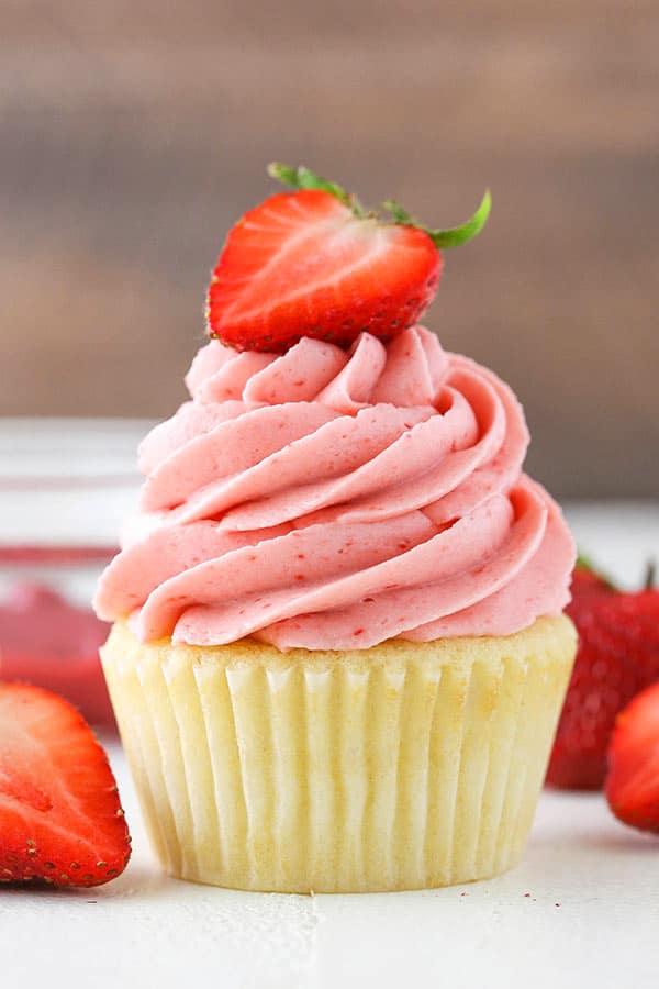 cupcake with strawberry frosting on top from the side