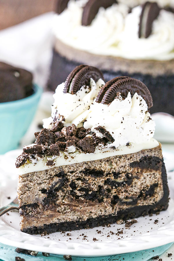 A slice of Oreo cheesecake on a white plate