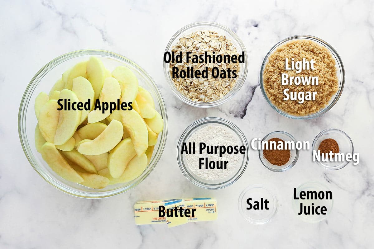 Ingredients for apple crisp on marble countertop