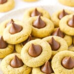 A white plate with a stack of classic peanut butter blossom cookies