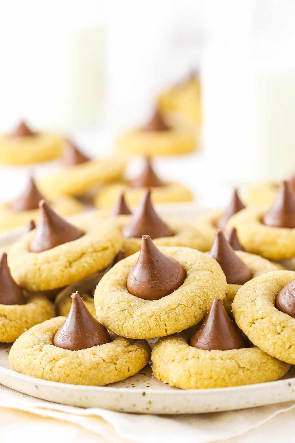 Peanut butter blossom cookies in a pile on a plate. 