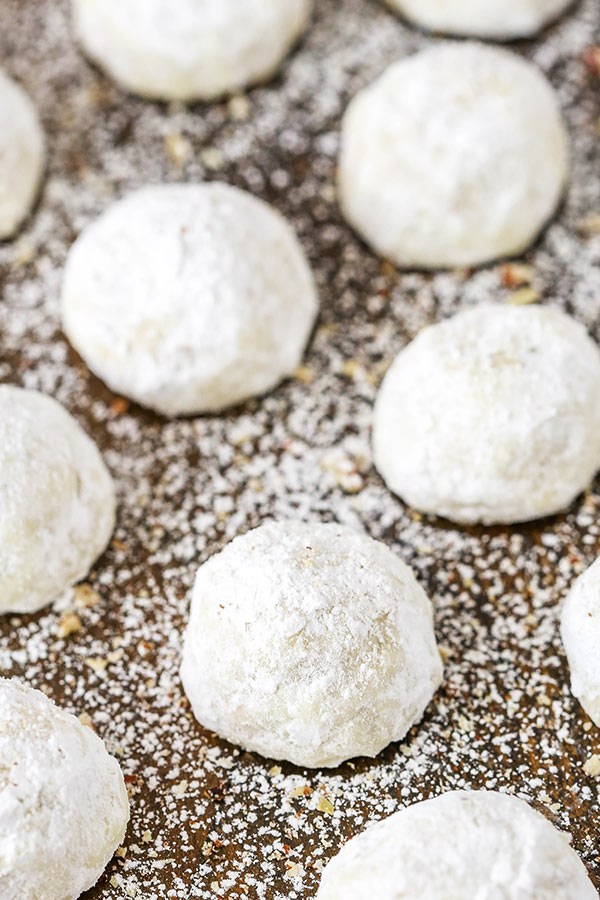 Snowball cookies dusted with sugar on a counter