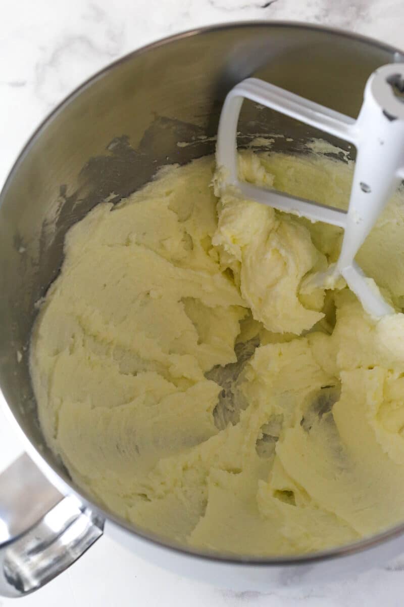 Spritz cookies are buttery, classic Christmas cookies made with a cookie press. This recipe is easy to make, with so many ways to decorate! Creamed butter and sugar in a mixing bowl.