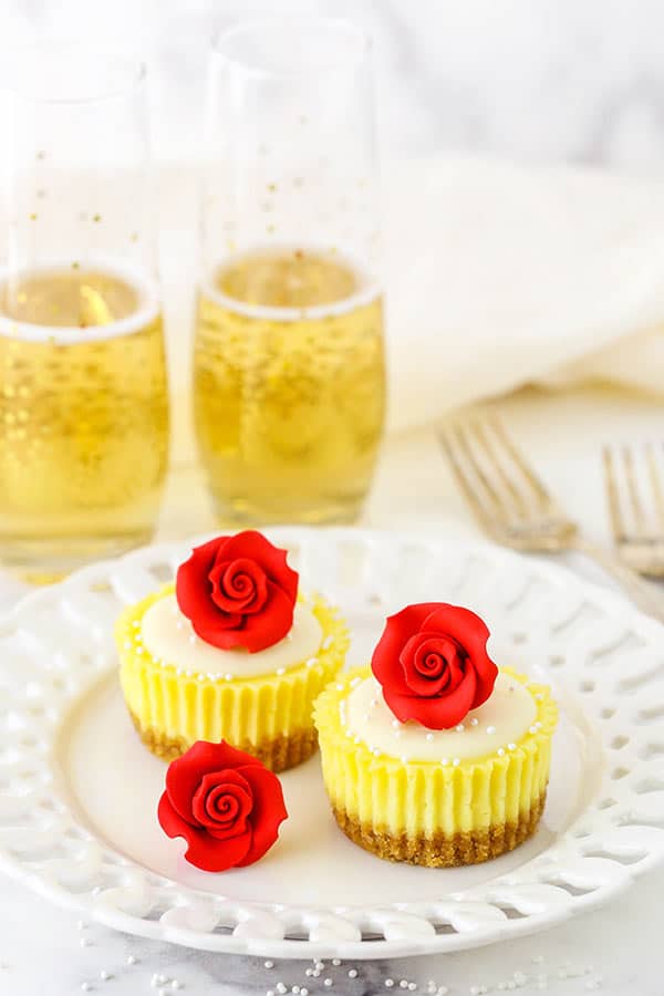 Mini Rose Cheesecakes on plate with champagne in background