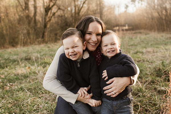 image of Lindsay kneeling with arms around the twins