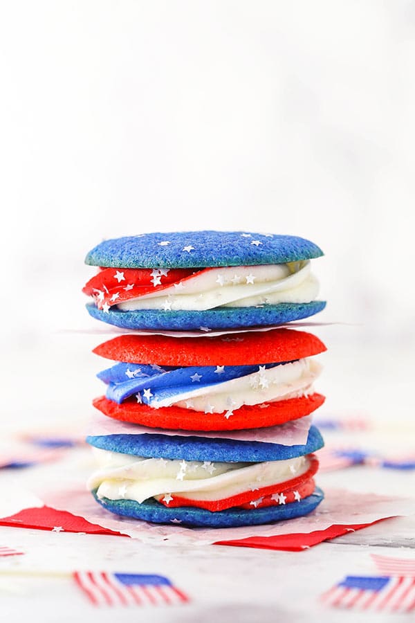 red, white and blue cookie sandwiches in a stack of three