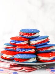 cookie sandwiches stacked on a silver plate