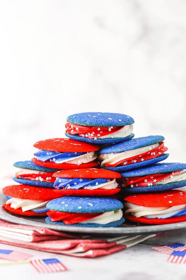 cookie sandwiches stacked on a silver plate
