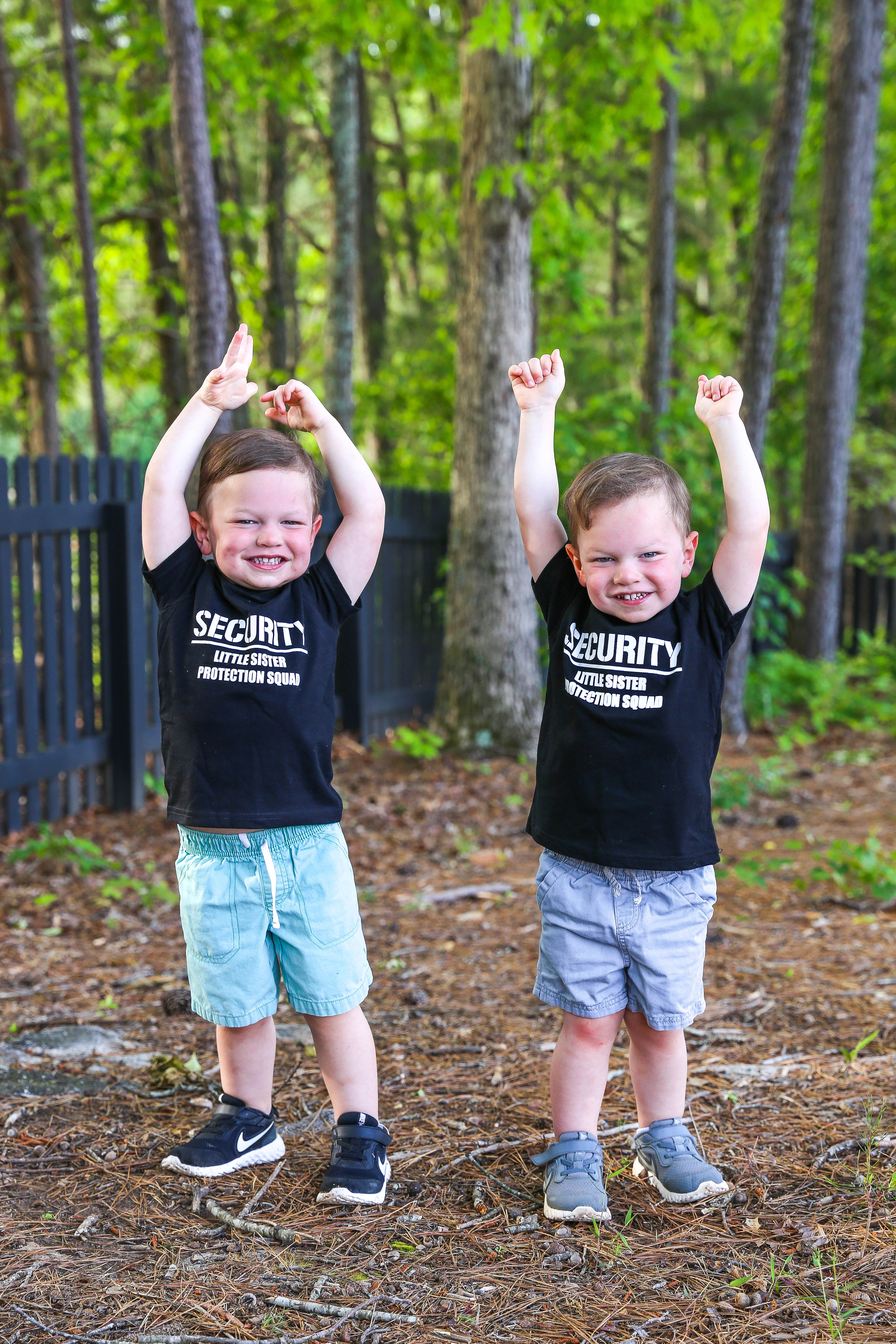 ashton and brooks showing their muscles in the tshirts that say "security - little sister protection squad"