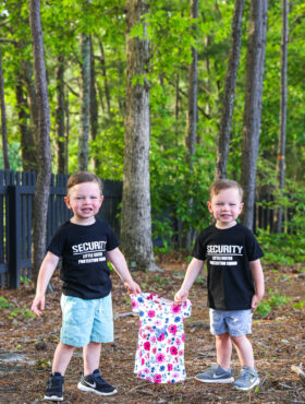 ashton and brooks holding a little girl dress