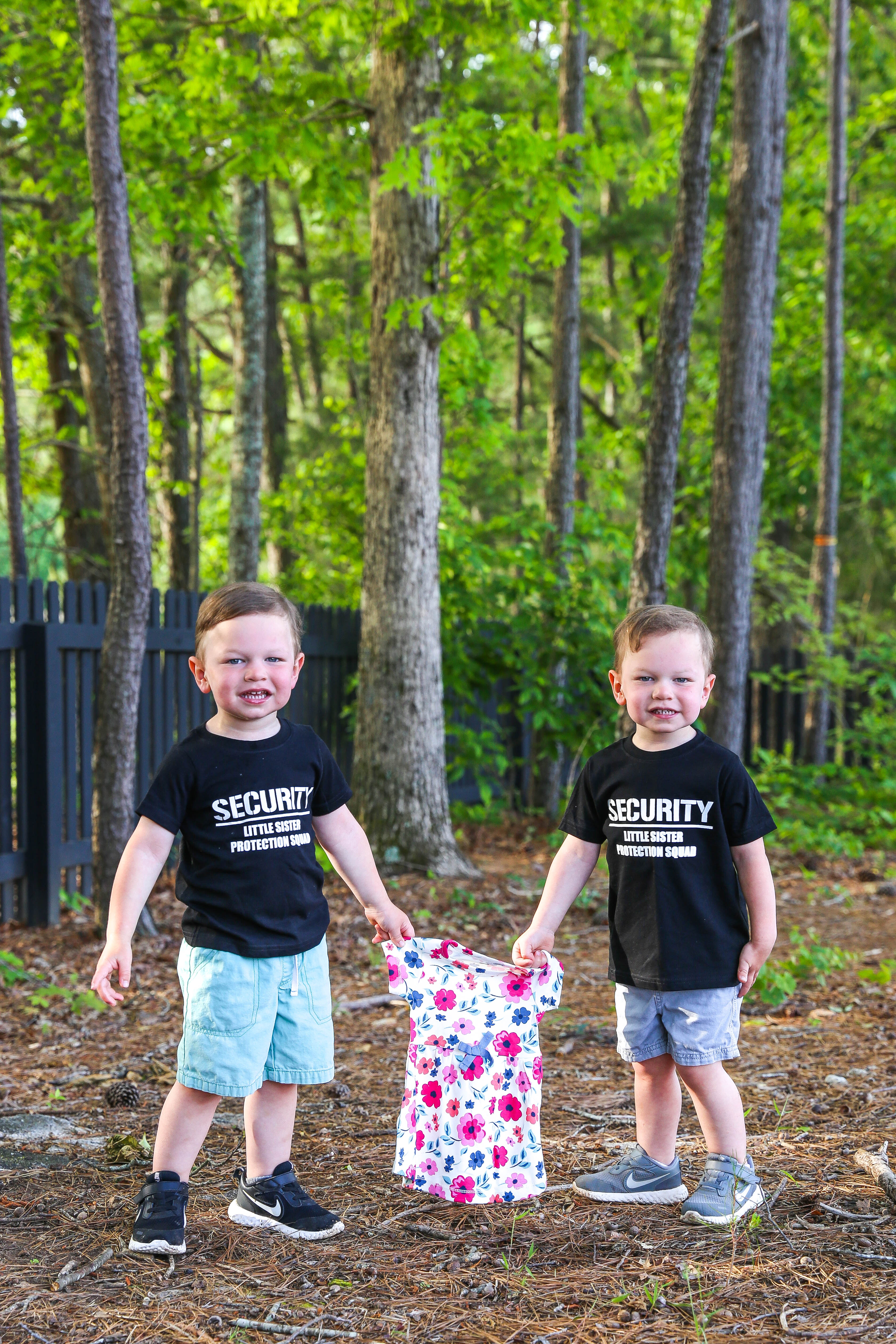 ashton and brooks holding a little girl dress