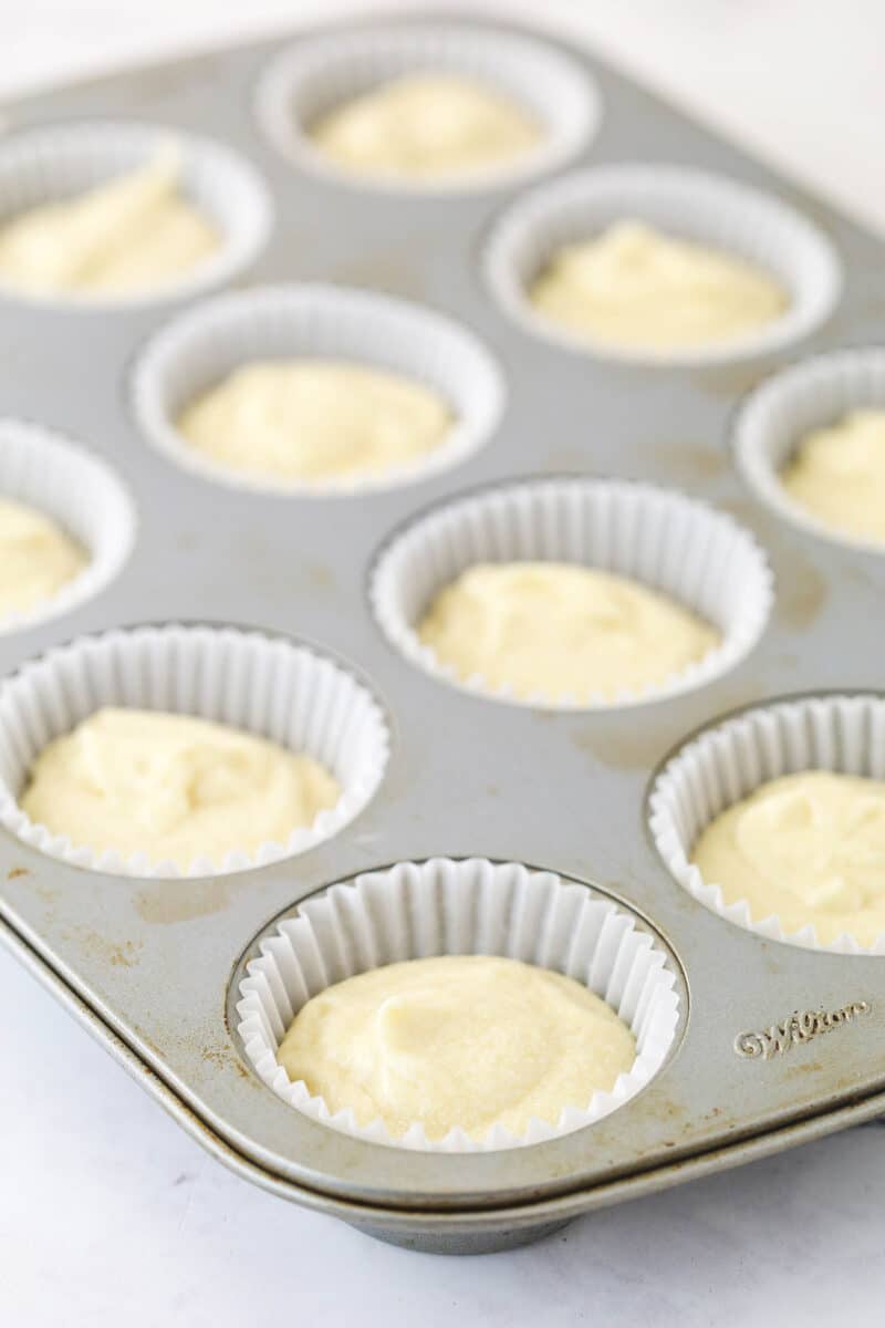These zucchini brownies are not only quick and easy to make, they have the perfect super dense and fudgy texture. Overhead view of batter added to cupcake pan with cupcake liners