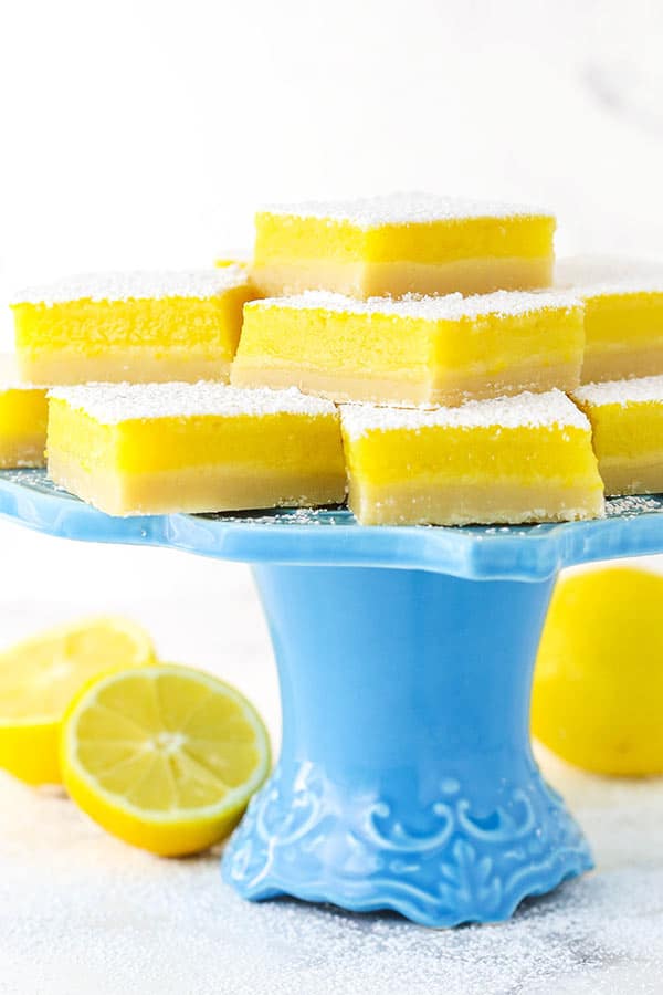 Lemon Bars on a Cake Stand with Sliced Lemons