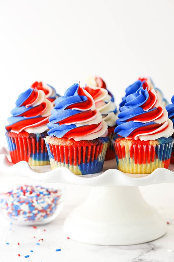 close up of red, white and blue cupcakes on a cake stand