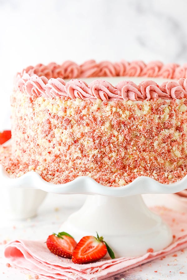 strawberry crunchie ice cream cake - full cake on white cake stand - close up