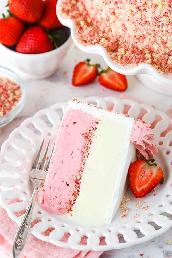 slice of strawberry crunchie ice cream cake - half vanilla ice cream and half strawberry