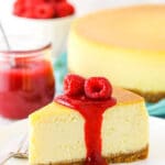 A Slice of New York Style Cheesecake Topped with Raspberries