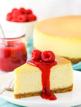 A Slice of New York Style Cheesecake Topped with Raspberries