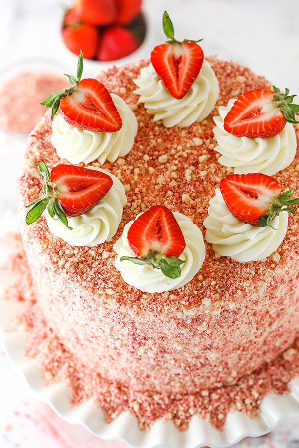 overhead image of strawberry crunchy cake with swirls and strawberries on top