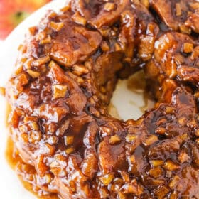 Overhead view of Apple Fritter Monkey Bread on a white cake stand