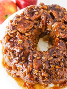 Overhead view of Apple Fritter Monkey Bread on a white cake stand