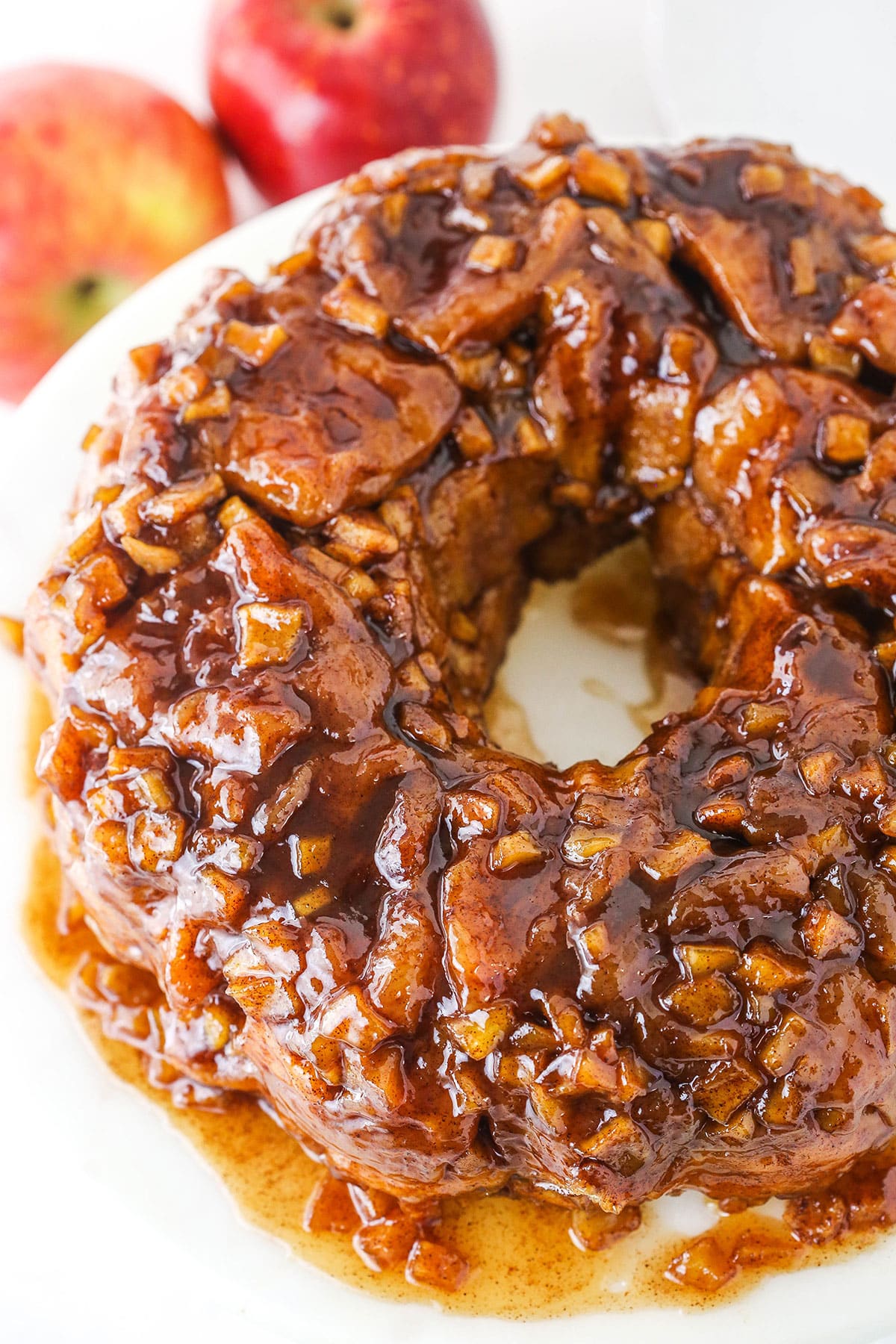 Overhead view of Apple Fritter Monkey Bread on a white cake stand