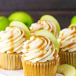 Caramel Apple Cupcakes topped with frosting swirls, a slice of apple and caramel sauce