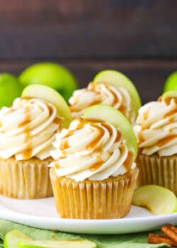 Caramel Apple Cupcakes topped with frosting swirls, a slice of apple and caramel sauce