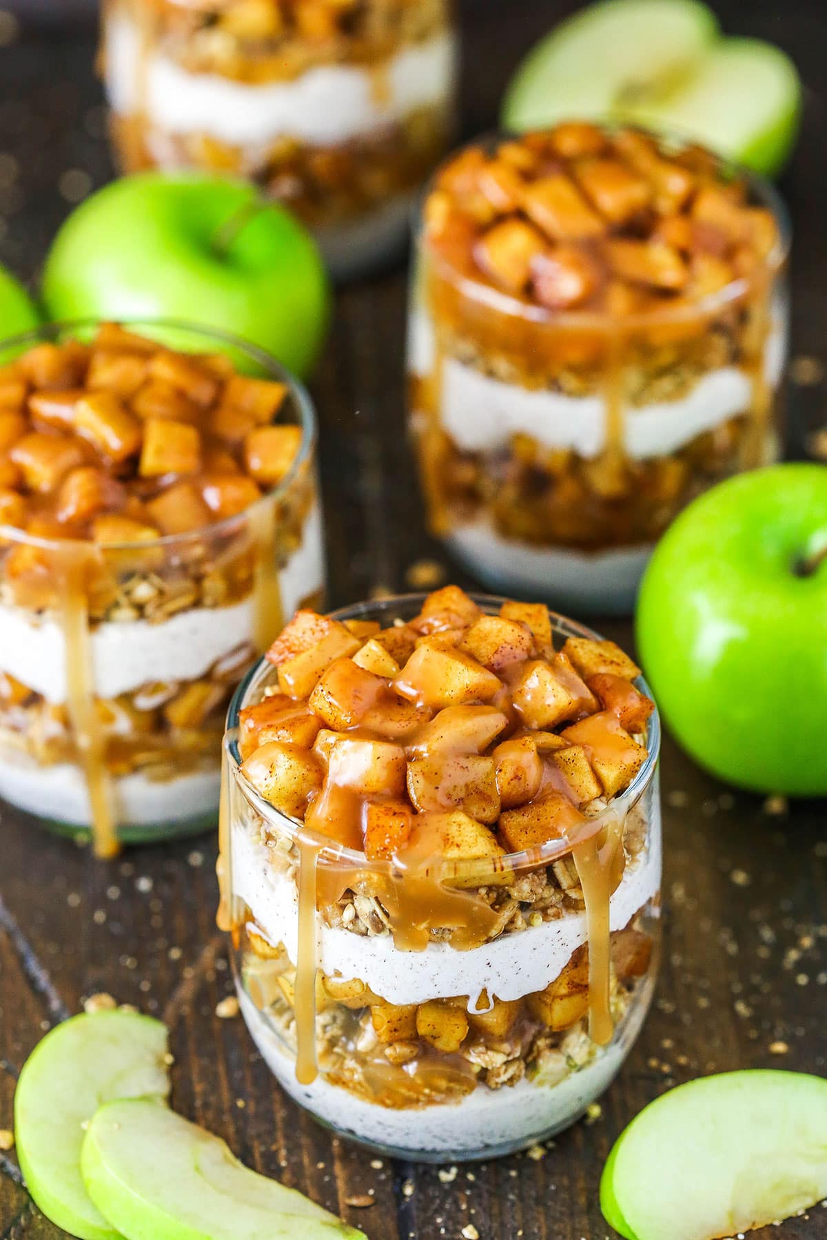 These Caramel Apple Trifles are the perfect apple treat for fall - no bake, super easy and full of cinnamon! Overhead view of Caramel Apple Trifles with some apples around them