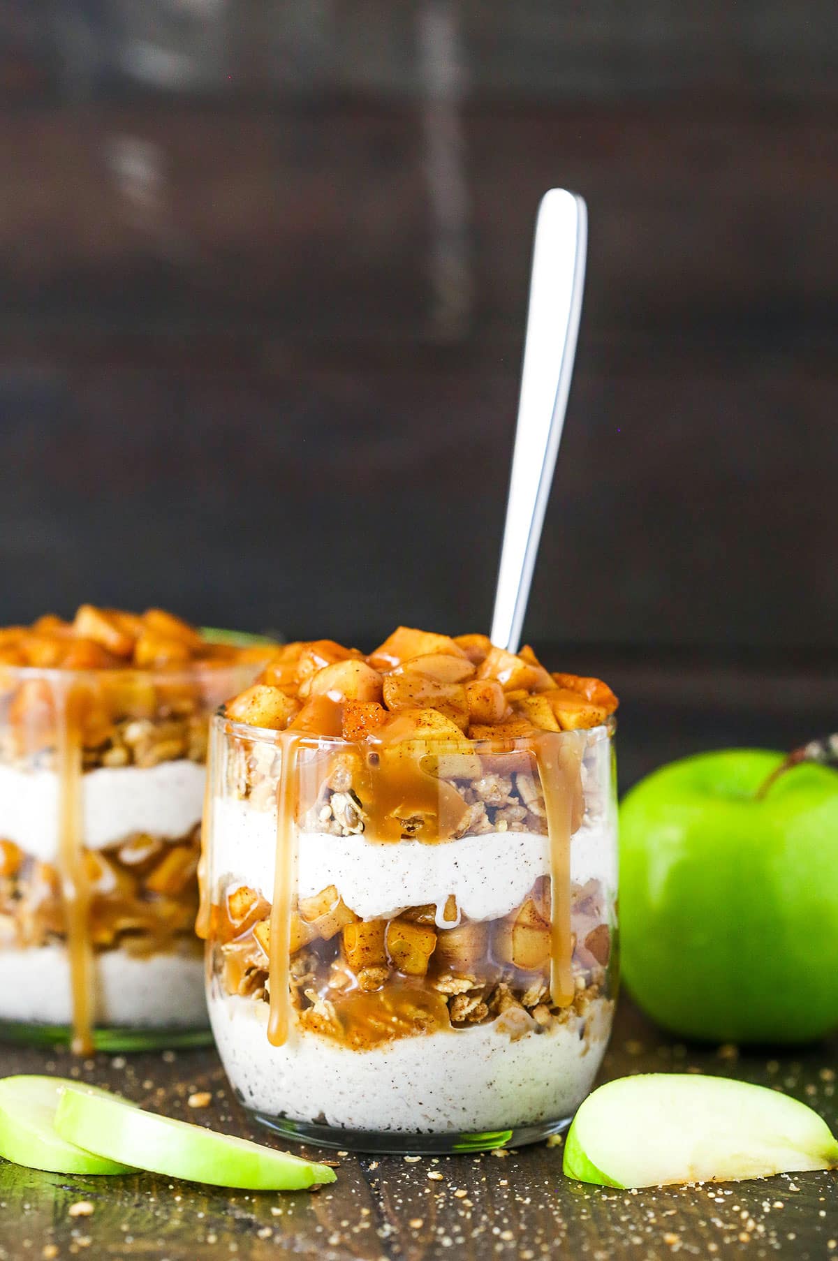 These Caramel Apple Trifles are the perfect apple treat for fall - no bake, super easy and full of cinnamon! A side image of a Caramel Apple Trifle with a spoon in it