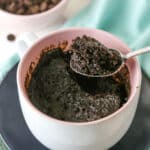 Overhead view of a Chocolate Mug Cake with a bite being removed with a spoon.