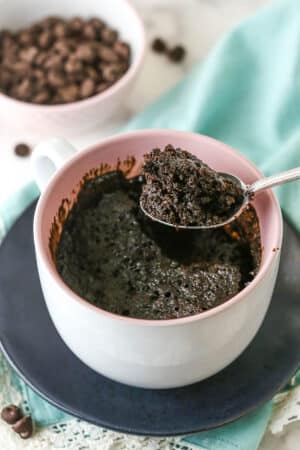 Overhead view of a Chocolate Mug Cake with a bite being removed with a spoon.