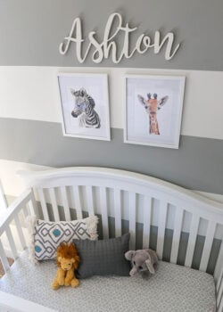 Ashton's Crib with A Zebra and Giraffe Painting On the Wall Above it