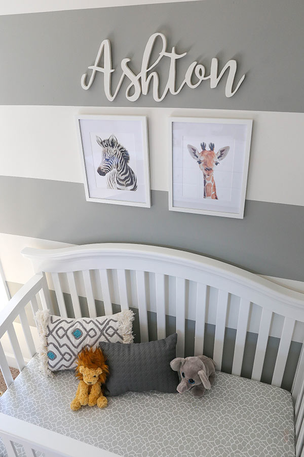 Ashton's Crib with A Zebra and Giraffe Painting On the Wall Above it