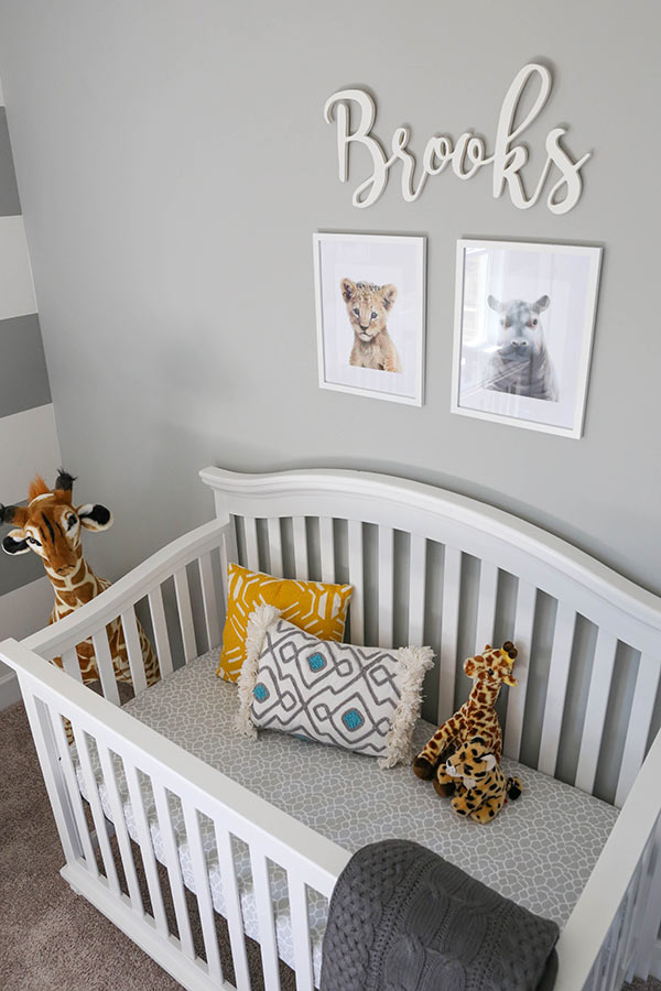 Brooks' Crib with a Lion Cub and Hippo Painting Hanging on the Wall Above