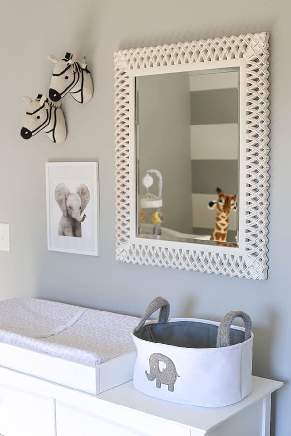 The Mirror Above the Changing Table with Animal Decorations on the Wall