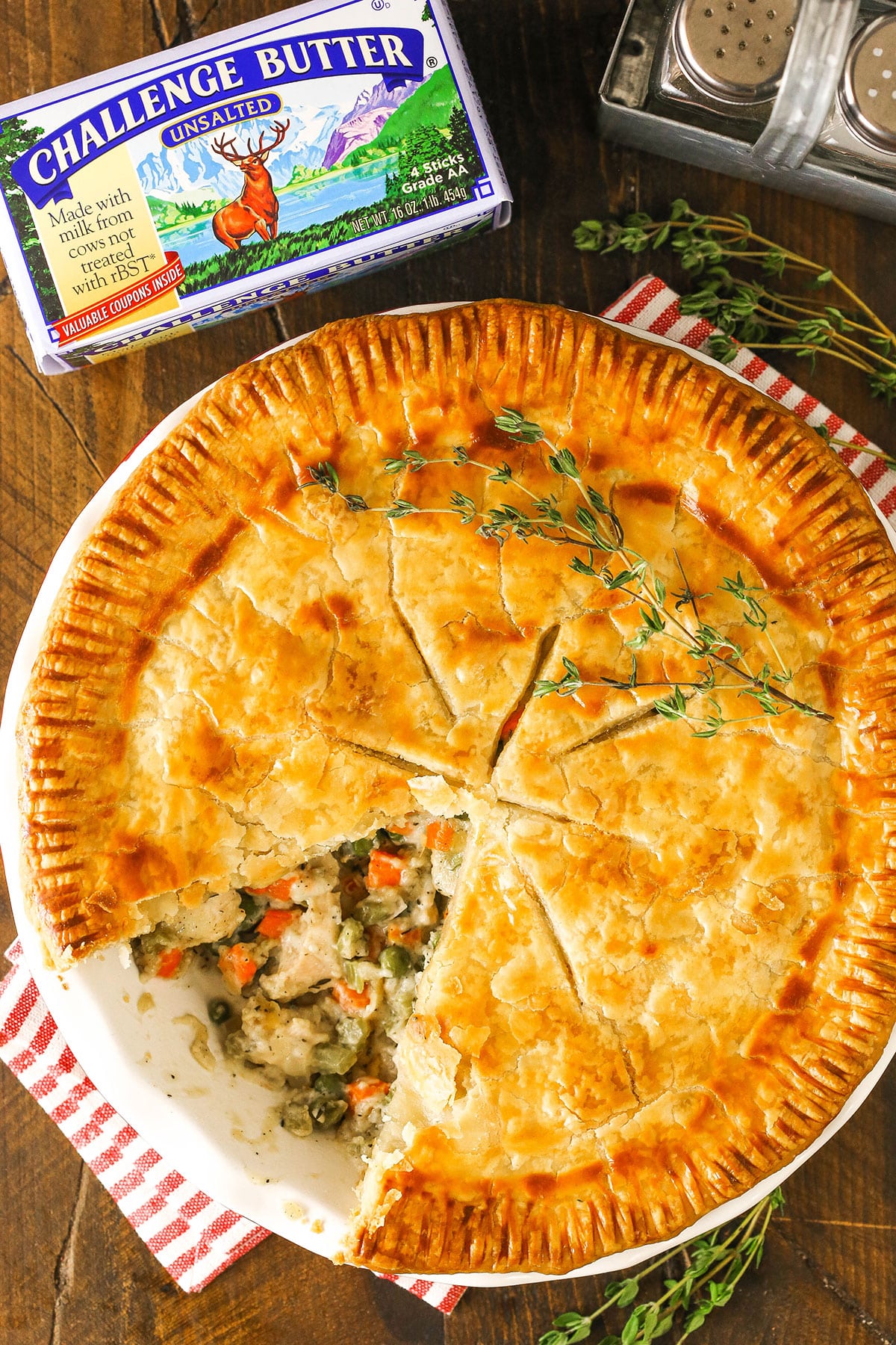 chicken pot pie with a slice taken and challenge butter package