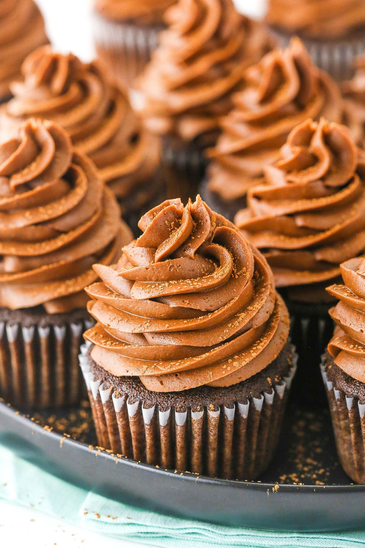 close up of chocolate cupcake on black platter