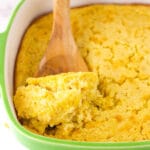 A Wooden Spoon Scooping out a Serving of Creamy Cornbread Casserole