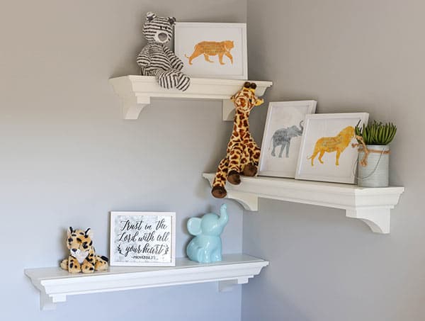 Three Floating Shelves on the Nursery Wall Displaying Animal Safari Decor