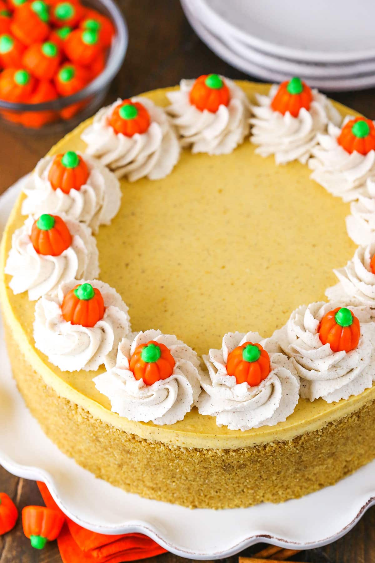 A Pumpkin Cheesecake with Swirls of Whipped Cream and Pumpkin Candies