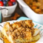 A slice of Overnight Cinnamon French Toast Casserole with syrup on a white plate