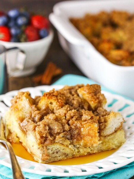 A slice of French toast casserole with syrup on a white plate.