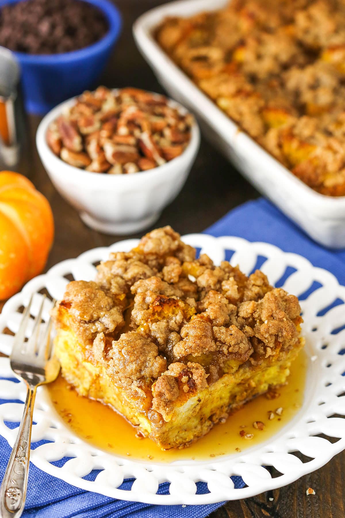 Overhead view of a square serving of Overnight Pumpkin Spice French Toast Casserole on a white plate with a fork