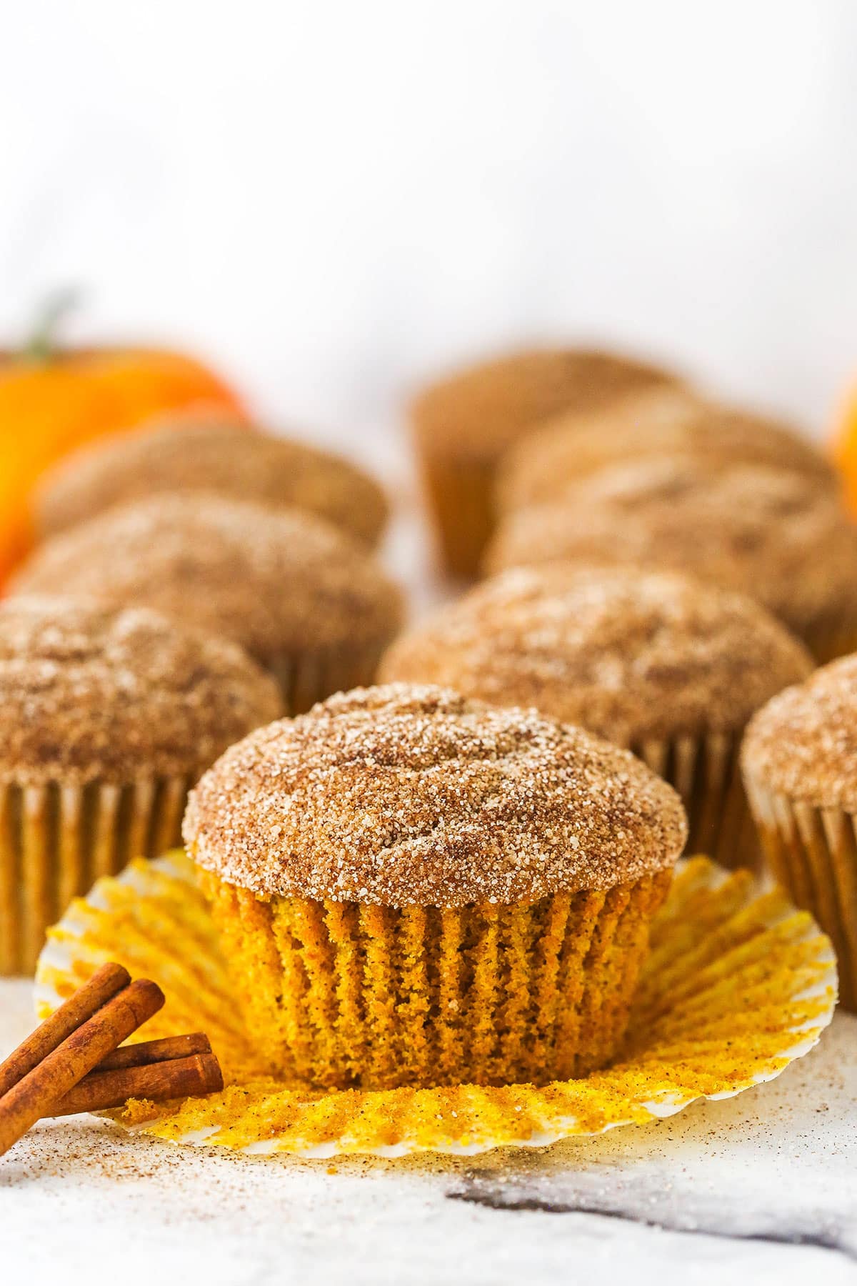 cinnamon sugar pumpkin muffins with liner pulled off