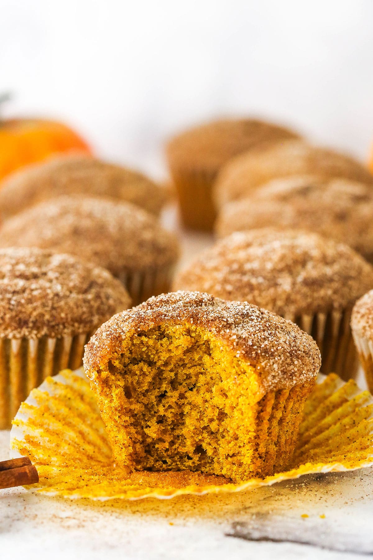 cinnamon sugar pumpkin muffin with bite taken out