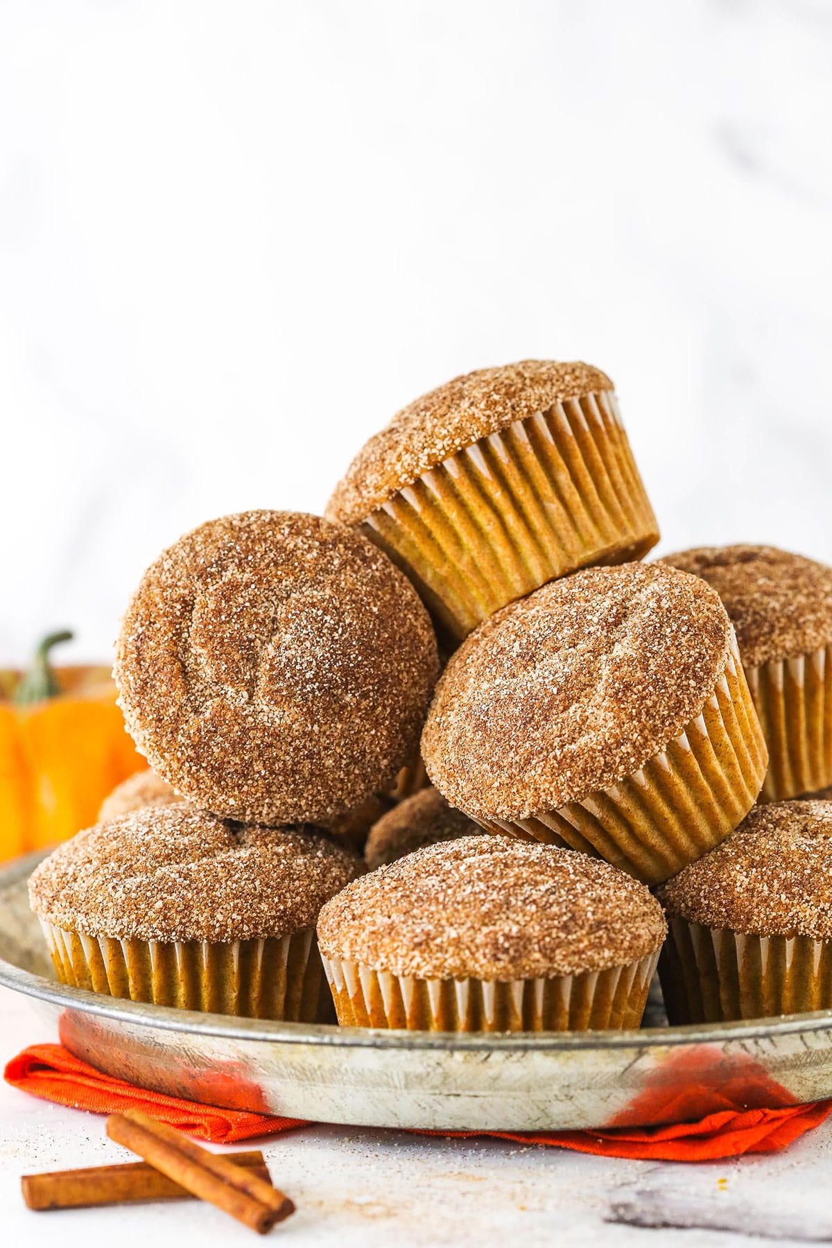 cinnamon sugar pumpkin muffins piled on metal dish