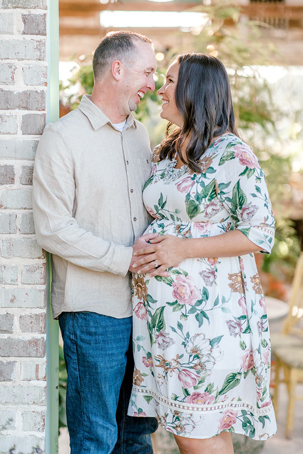 Lindsay and husband standing in doorway smiling at each other