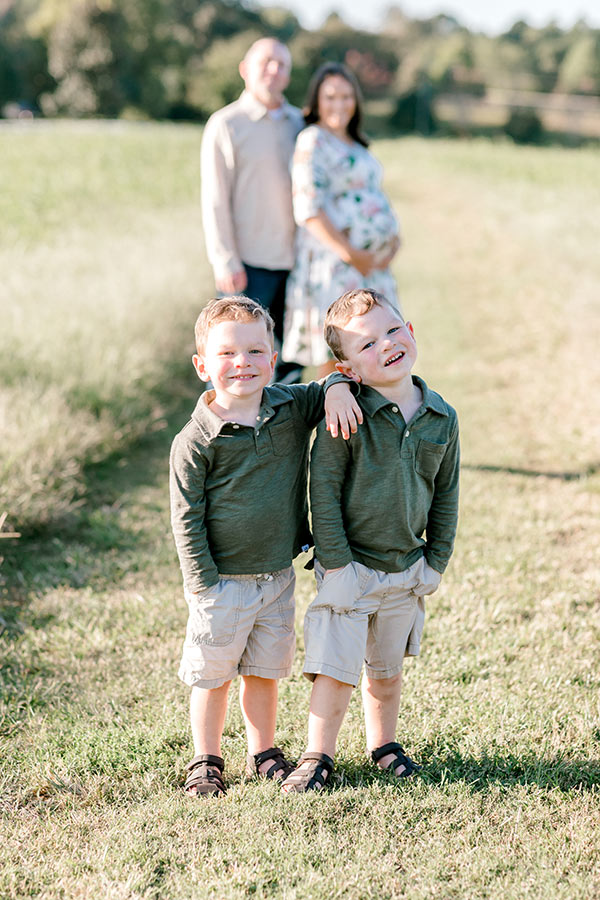 Brooks and Ashton posing together with Lindsay and husband in background